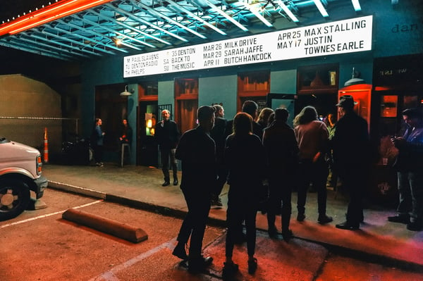 A crowd gathers outside a Denton Texas music venue.jpg