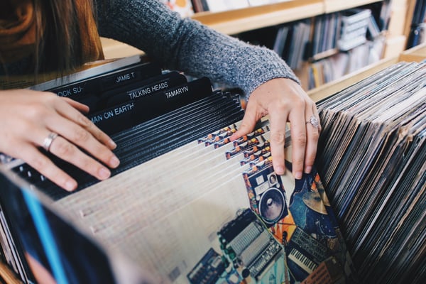 A person sorts through vinyl records at a record store.jpg
