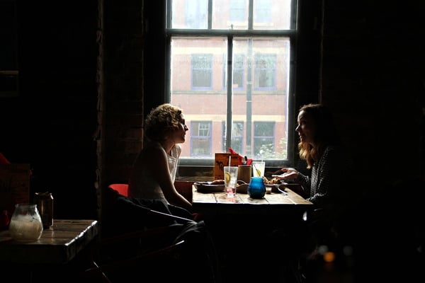 two_women_having_a_conversation_in_a_restaurant.jpg