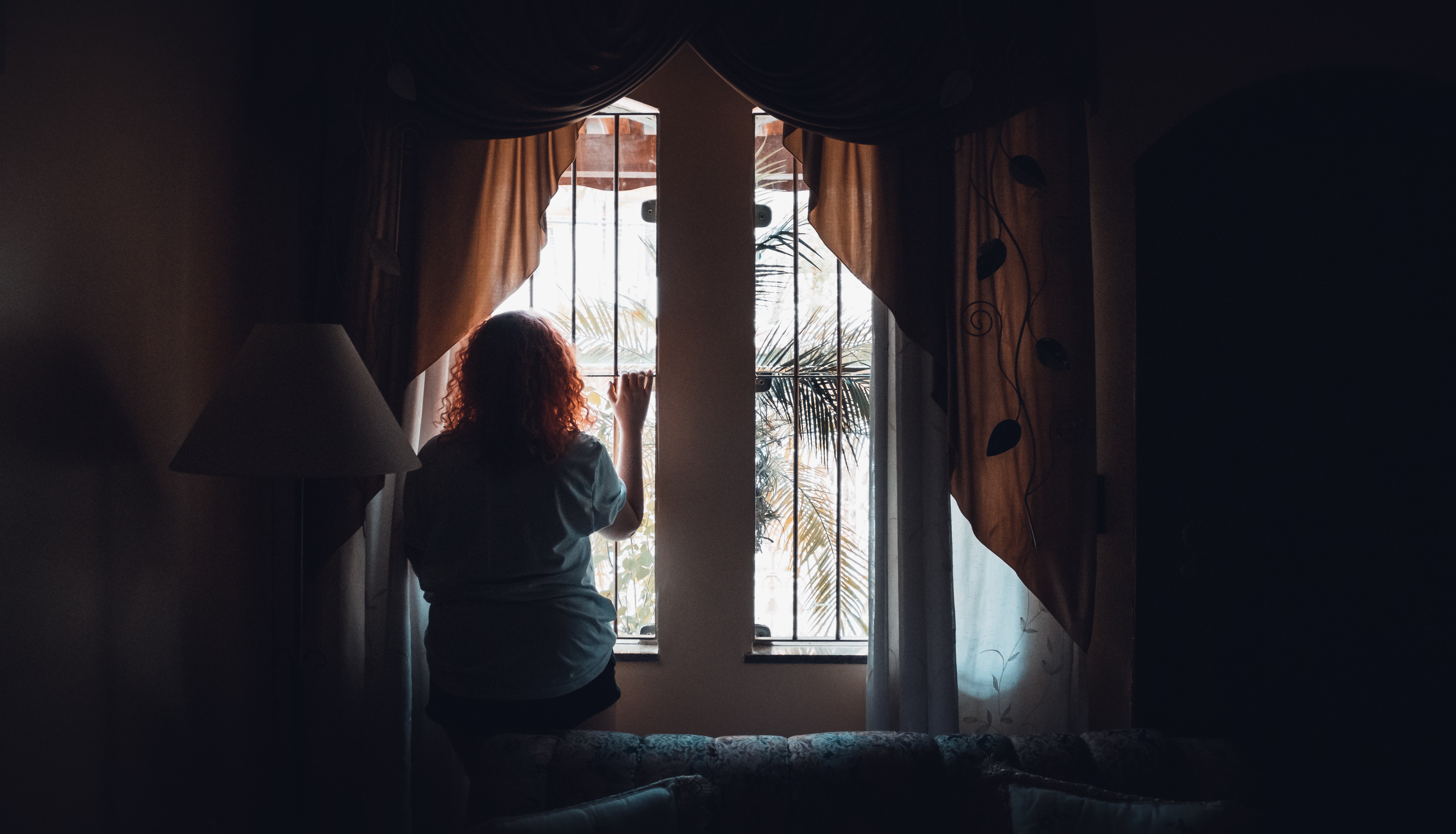 woman-standing-in-front-of-a-window-3264254